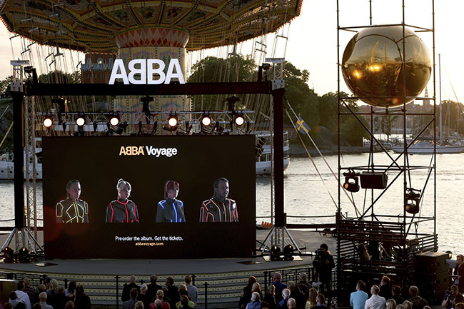 A view of a screen at the ABBA Voyage event at Grona Lund, in Stockholm, Sweden, Thursday, Sept. 2, 2021. ABBA is releasing its first new music in four decades, along with a concert performance that will see the “Dancing Queen” quartet going entirely digital. The forthcoming album “Voyage,” to be released Nov. 5, is a follow-up to 1981′s “The Visitors,” which until now had been the swan song of the Swedish supergroup. And a virtual version of the band will begin a series of concerts in London May 27.   (Fredrik Persson/TT News Agency via AP)