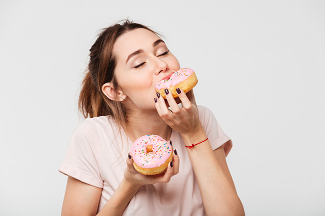 eating donuts shutterstock 766032388