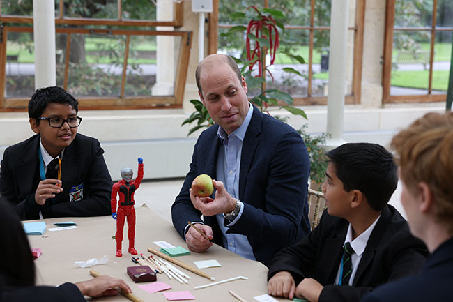 Britain's Prince William alongside children from The Heathlands School during a visit to the Royal Botanic Gardens, in south London, Wednesday, Oct. 13, 2021 to take part in a Generation Earthshot event. (Ian Vogler/Pool Photo via AP)