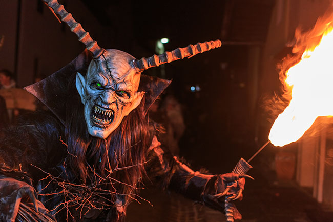 PODKOREN, SLOVENIJA - NOVEMBER 24th 2017: Unidentified man wears Krampus (devil) mask at traditional procession  