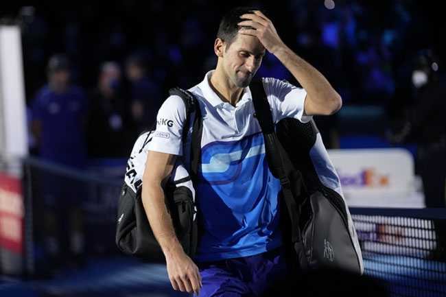 Novak Djokovic of Serbia leaves the court after losing to Alexander Zverev of Germany in their ATP World Tour Finals, singles semifinal, tennis match, at the Pala Alpitour in Turin, Italy, Saturday, Nov. 20, 2021. Zverev won 7-6/4-6/6-3. (AP Photo/Luca Bruno)