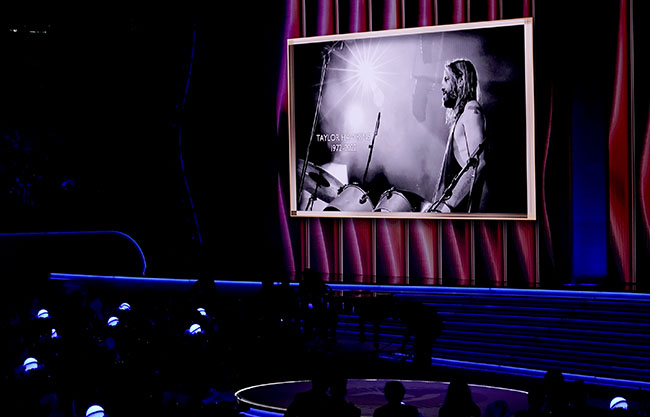 The late Taylor Hawkins appears on screen during an In Memoriam tribute at the 64th Annual Grammy Awards on Sunday, April 3, 2022, in Las Vegas. (AP Photo/Chris Pizzello)