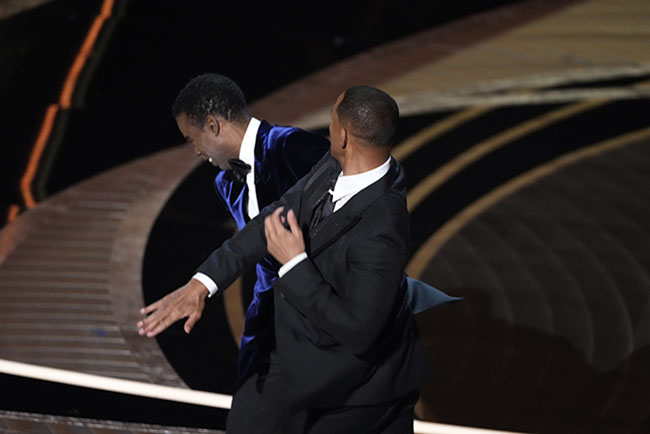 Mar 27, 2022; Los Angeles, CA, USA; Will Smith confronts Chris Rock as he presents the award for best documentary feature during the 94th Academy Awards at the Dolby Theatre. Mandatory Credit: Robert Hanashiro-USA TODAY/Sipa USA /AAP Image